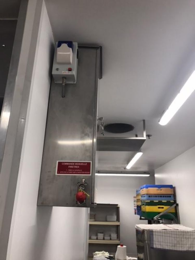 On retrouve ici une installation d'un système d'extinction automatique TRACEFLAM, pour la protection des friteuses et de la hotte aspirante.
